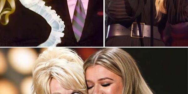 Just days after losing the love of her life, Carl Dean, Dolly Parton sat quietly in the audience — grief etched on her face, her heart visibly shattered. The world saw a legend, but in that moment, she was simply a woman in mourning. Then, Kelly Clarkson stepped onto the stage.