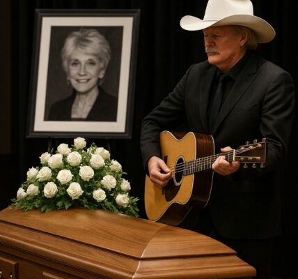 No press. No spotlight. Alan Jackson arrived quietly at Jeannie Seely’s funeral — just a man in black, stepping into sacred silence. The chapel, soft with white flowers and golden light, seemed to hold its breath as he stood.